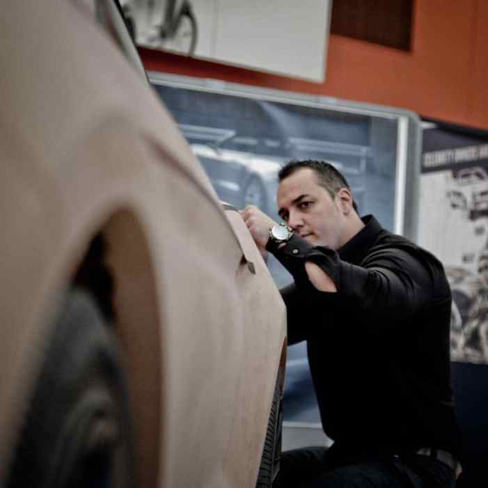 Exterior design manager Kemal Curic works on a clay model of the 2015 Ford Mustang