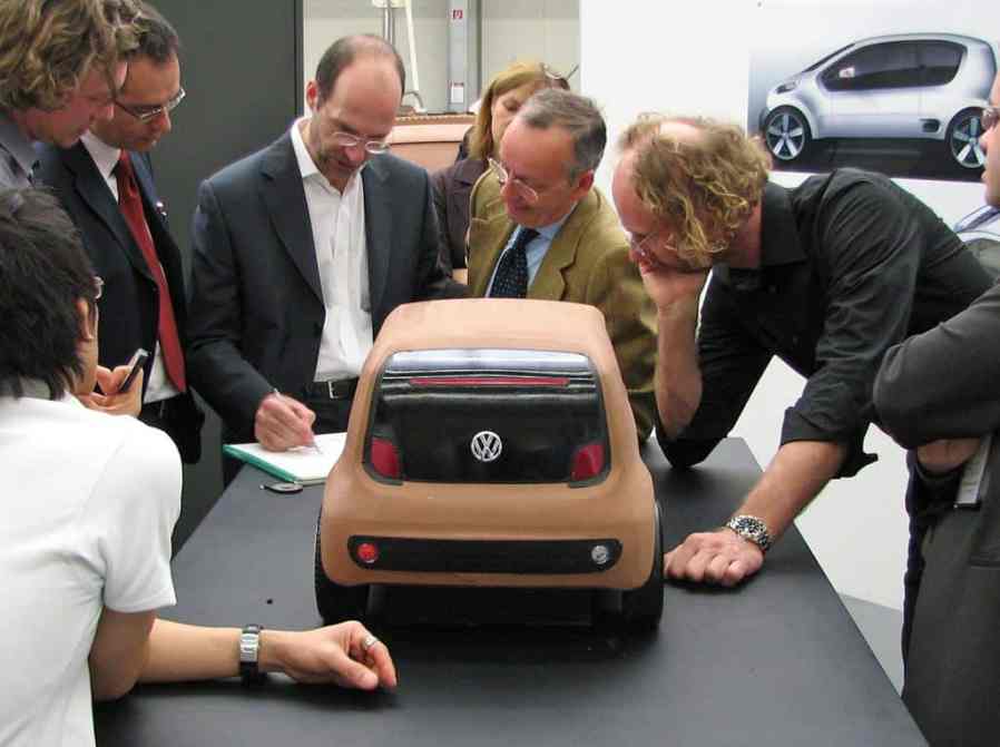 VW brand design director Klaus Bischoff (with pen in hand) with Walter de'Silva and current Audi design director Marc Lichte during a review of the scale model of the VW Up! concept