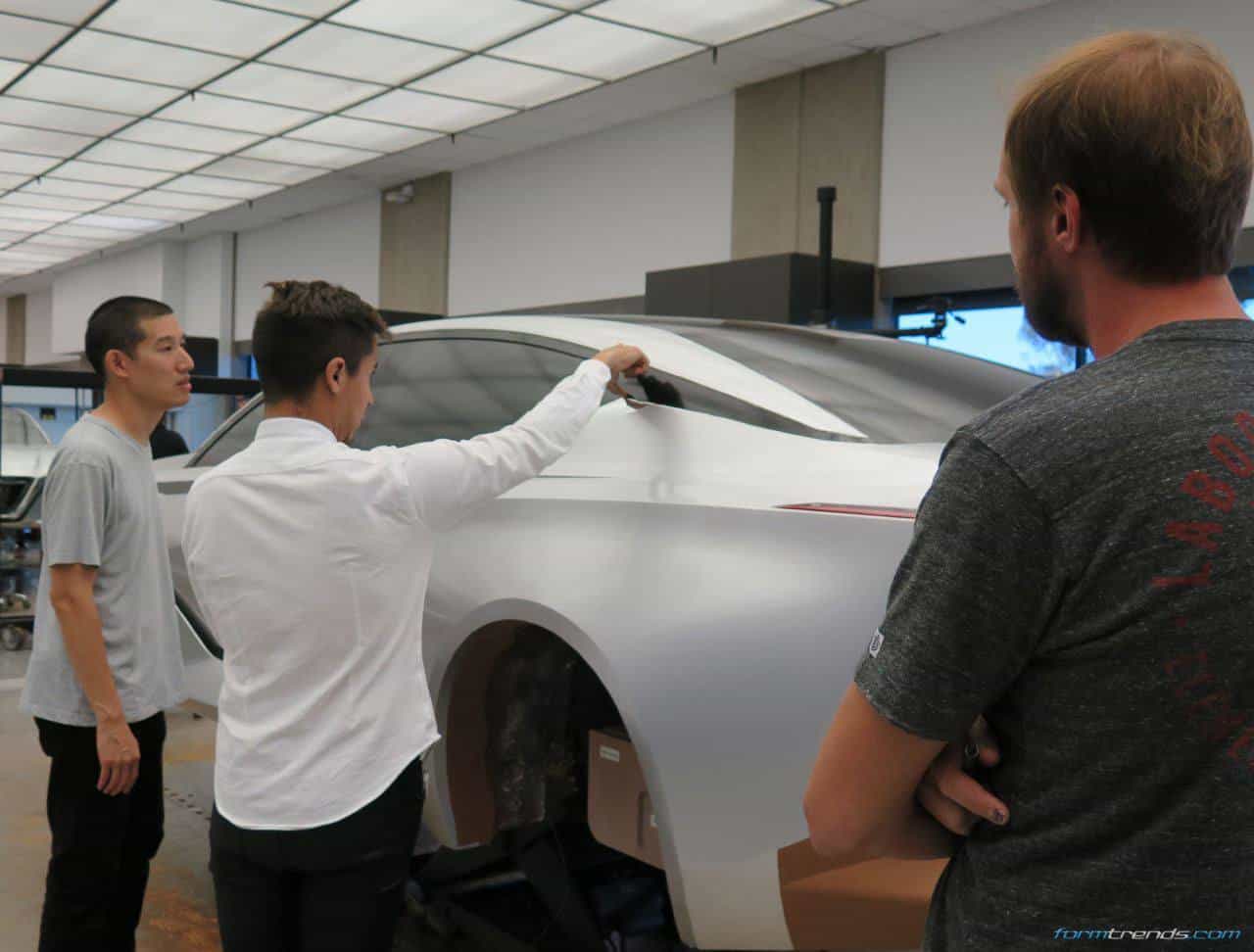 NDA design director Ken Lee, exterior designer Daniel Jimenez loom over a clay model of the Nissan Vmotion 2.0